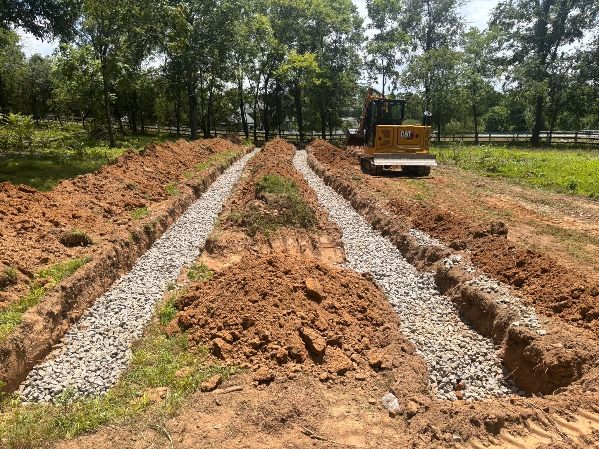 Septic system gravel trenches with excavator on a Lebanon, TN property Septic system gravel trenches with excavator on a Lebanon, TN property